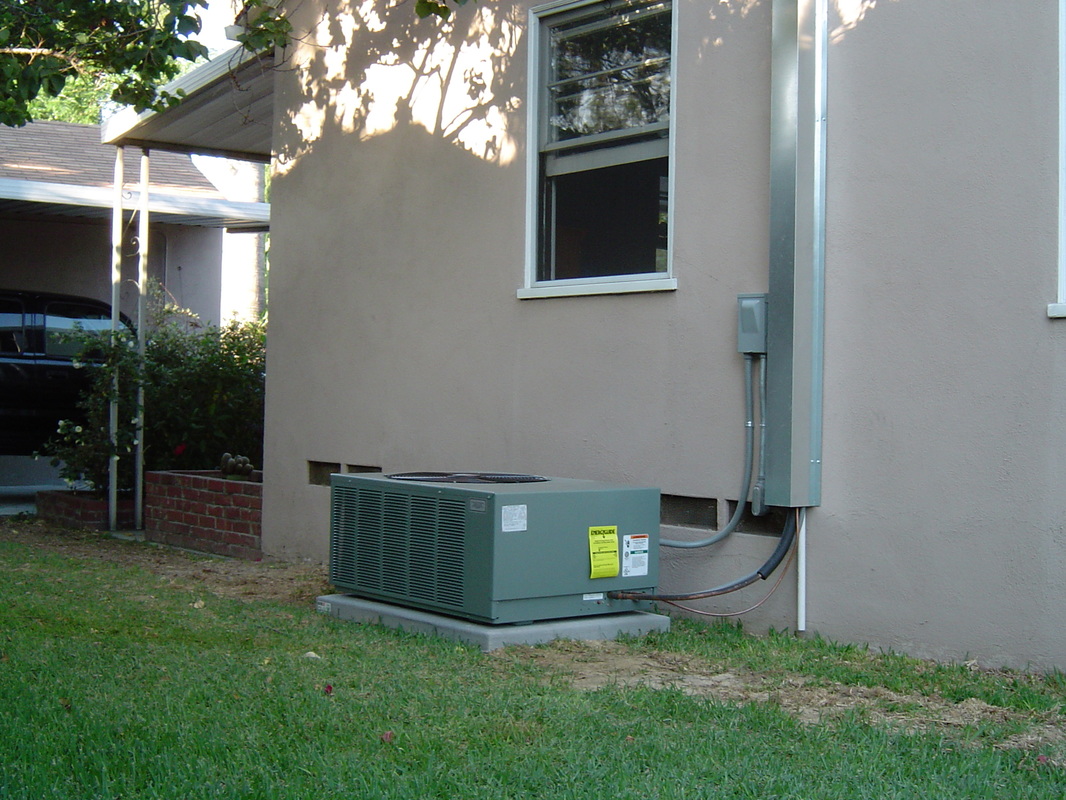 Small town house with air conditioning unit.