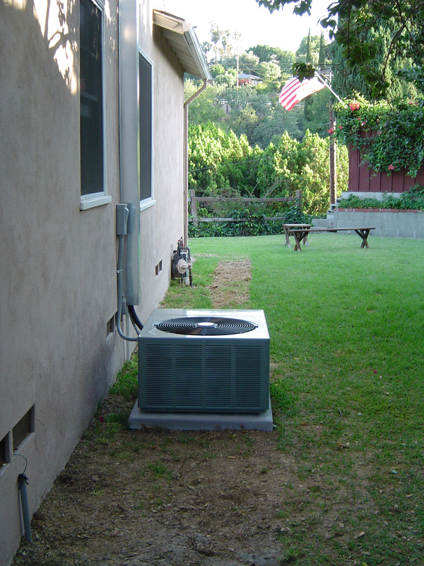 Small town house with air conditioning unit.